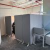 Grey free-standing acoustic dividers in an open-plan office